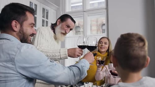 Happy Multi-Generation Family Celebrating with Wine