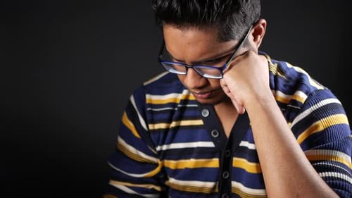 Young Adult Resting Head on Hand in Studio