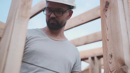 Civil Engineer Takes Measurements at a Construction Site, From Below