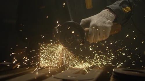 Gloved Hand Cutting Metal with Angle Grinder