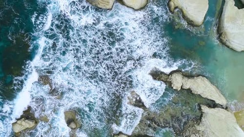 Charming Craggy Beach in Cyprus a Geological Wonder Sea Waves Splash Against Beach with Rocks