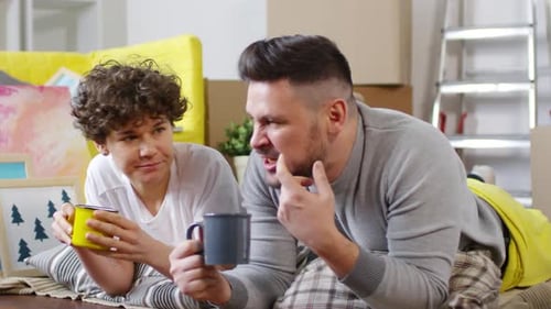 Couple Relaxing with Tea in New Apartment