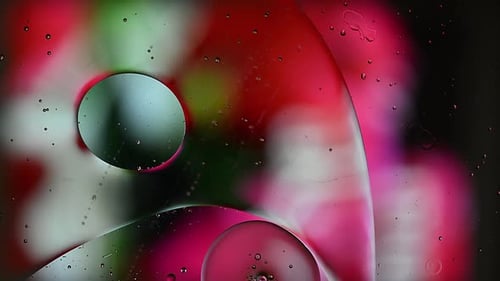 Abstract Colorful Food Oil Drops Bubbles and spheres Flowing on Water Surface