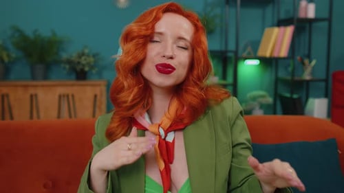 Smiling Redhead Gesturing and Grooving on Couch