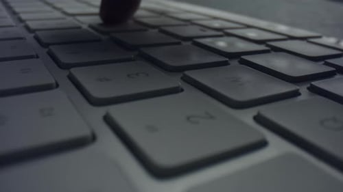 Fingers Type on Computer Keyboard in Dark Setting