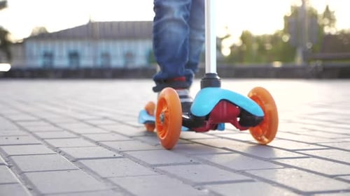 Boy Riding a Scooter on a Sunny Day