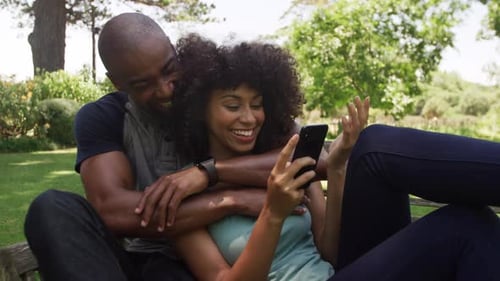 Happy mixed race couple enjoying in the garden during a sunny day