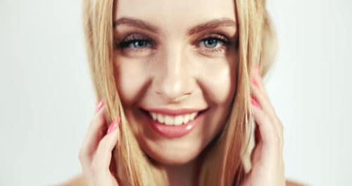 Blonde Woman Smiling and Posing in Studio