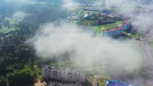 The Picturesque Green Environment-friendly City in the Early Morning Fog. Aerial View