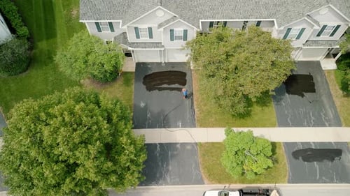 Aerial View of Driveway Sealcoating Pavement Near Private Houses in the Suburbs