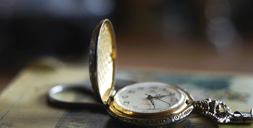 Vintage Gold and Silver Pocket Watch on Book