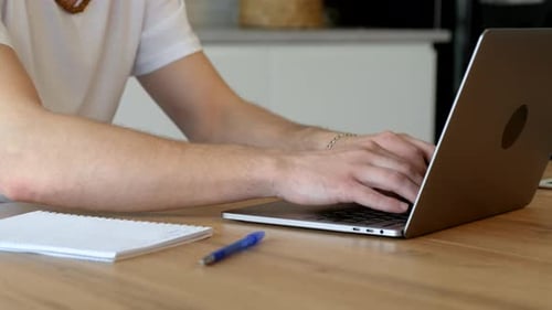 Person Typing on Laptop at Desk Indoors