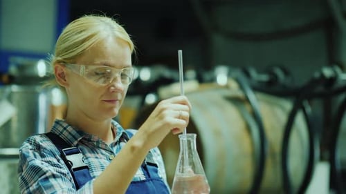 Female Researcher Working with Product Samples in a Flask