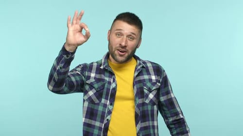 Man smiling and making the OK sign