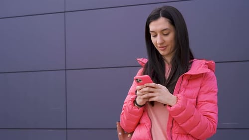 Young Woman Using Phone in Urban Environment