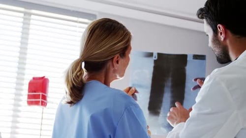 Doctors checking x-ray report