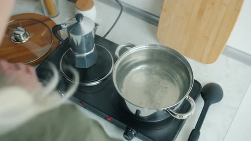 Cooking Spaghetti in Boiling Water on Cooktop