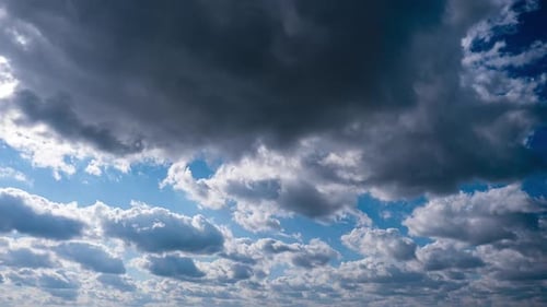 Timelapse of Gray Cumulus Clouds Moves in Blue Sky