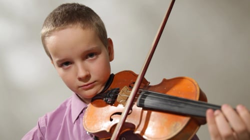 Focused Child Plays Violin Close Up