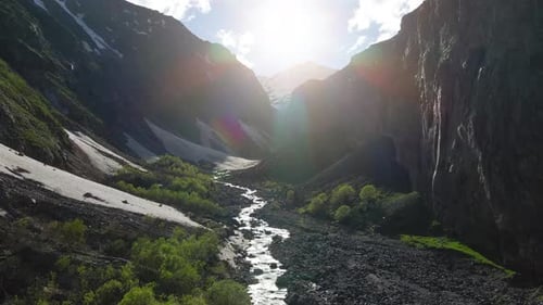 Aerial Flying in the Mountain Canyon with Snow Peak on the Background