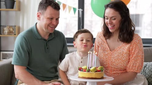 Family Celebrates a Child's Birthday with Cake