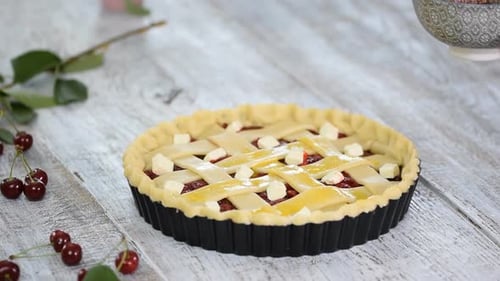 Hands Preparing Cherry Pie with Lattice Crust