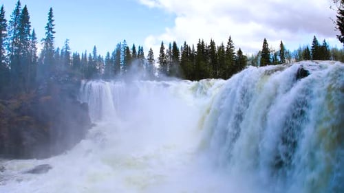 Majestic Waterfall Flowing Through Forest Wilderness