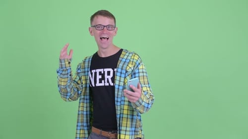 Excited Man Reacts to Phone News on Green Screen