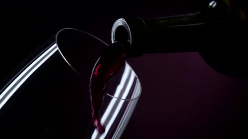 Pouring Red Wine into a Clear Glass