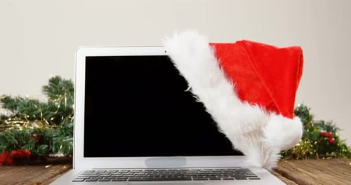 Laptop with santa hat on a plank 4k