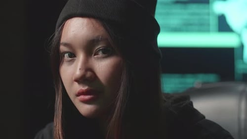 Close Up Asian Woman Hacker Using Computer Hacking And Looking, Pose To Camera