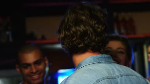 Friends Socializing at a Nighttime Urban Bar