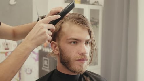 Young Adult Receiving Haircut in Barbershop