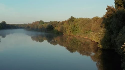 Beautiful morning, summer flight over the river. Fog, trees.