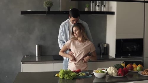 Affectionate Couple Embracing in Modern Kitchen