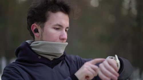 Young Man Using Smart Watch Outdoors