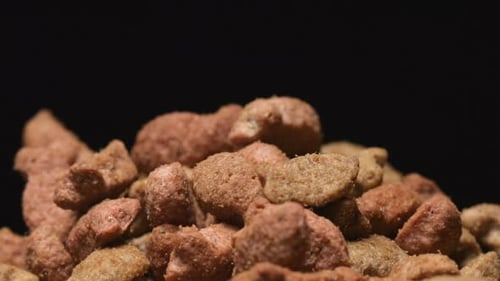 Macro shot of falling of pet food on a heap