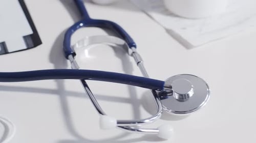 Close-up of different stuff and equipment on doctor's table in medical office in hospital.