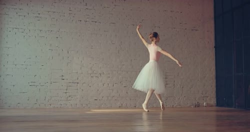Beautiful Ballerina Dancing Gracefully in a Bright Studio