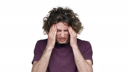Man Suffering Headache or Migraine Rubbing Head