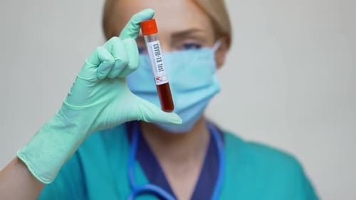 Medical Professional Holding COVID-19 Test Tube