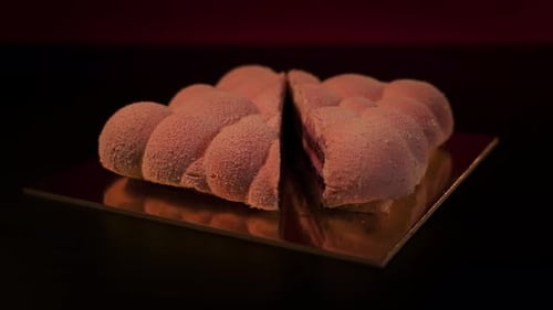 Pink Mousse Cake Cut in Half on Platter