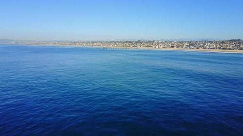 Aerial drone uav view of a pier over the beach and ocean.