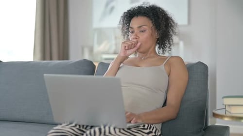 Woman Working on Laptop, Coughing Into Hand