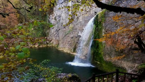 Scenic Waterfall in Autumn Forest