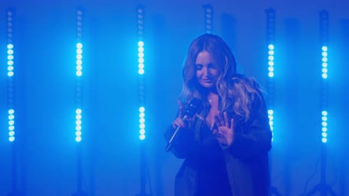 Woman Singing and Dancing on a Stage