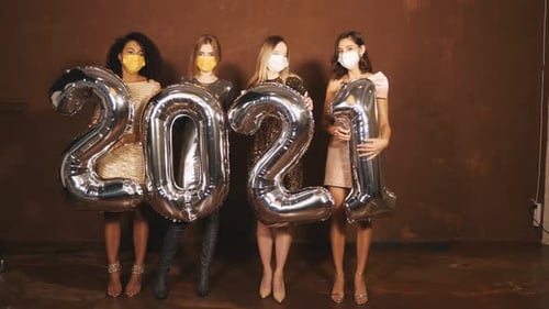 Women Holding 2021 Balloons and Wearing Masks