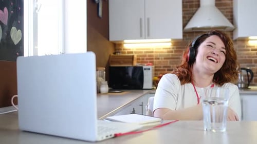 Woman Laughing While Working From Home