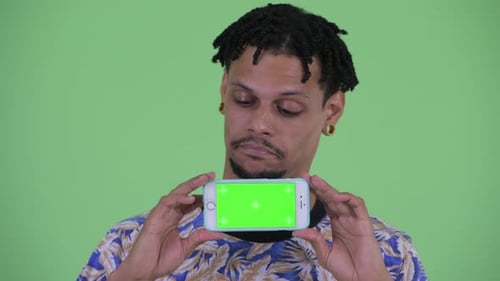 Man Holding Smartphone with Green Screen Smiling
