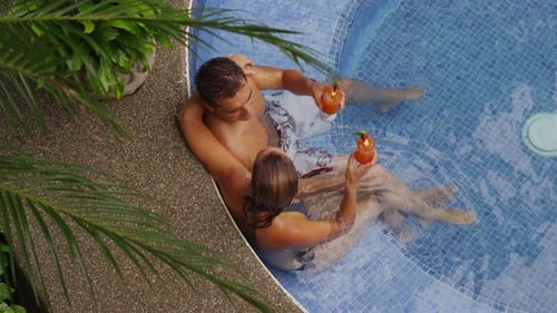 Couple sitting in hot tub together, over head shot. Shot on RED EPIC for high quality 4K, UHD, Ultra